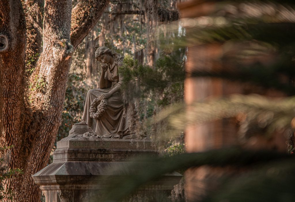 Contemplative female statue in a historic cemetery in Savannah