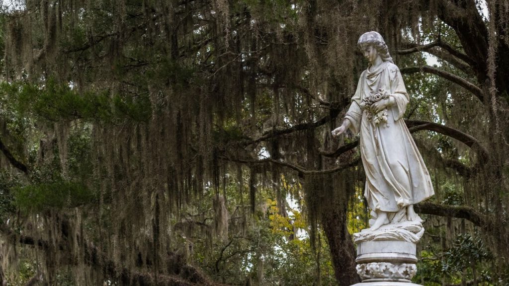 Female statue holding flowers in a Savannah cemetery