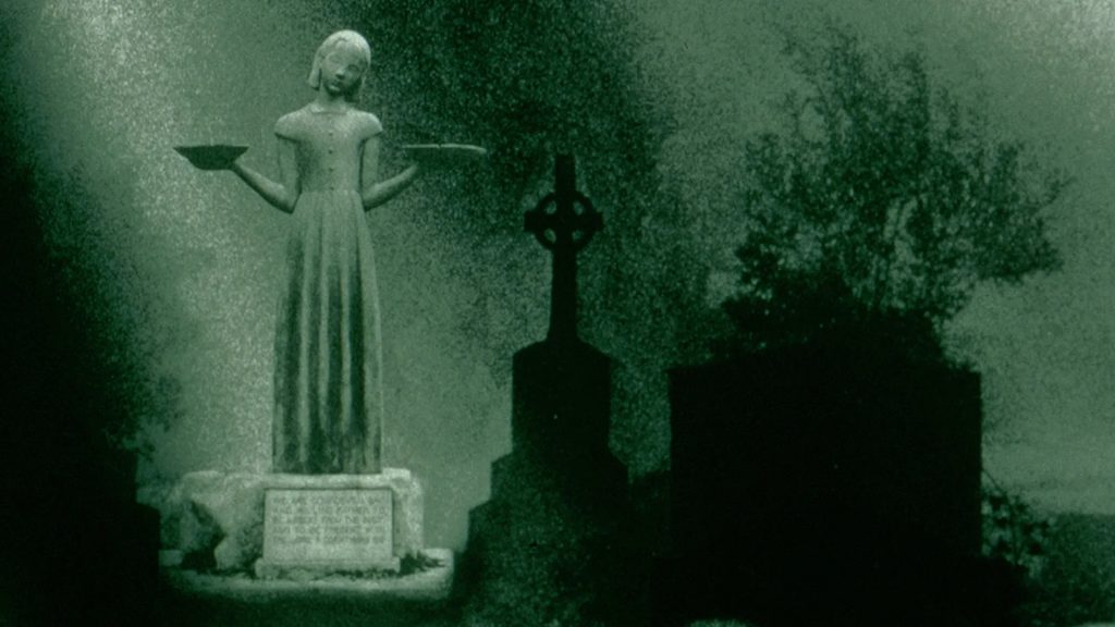 Female statue holding trays in a Savannah cemetery